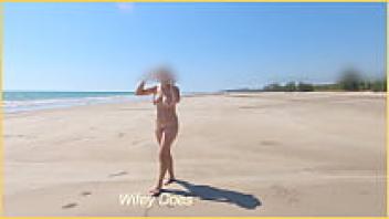 The wife is completely nude on a public beach.