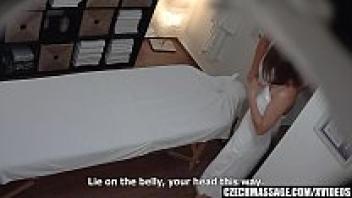 Seduction of a Young Brunette on a Massage Table with Glasses