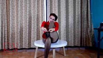 Pretty woman in heels and pantyhose. At the circular table C1, striptease