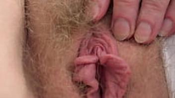 Close-up of a mature clitoris and pussy. Her hairy cunt is masturbated by a plump milf. Fetish for home. ASMR.