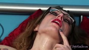 Babe with glasses applies a cumshot on her face.